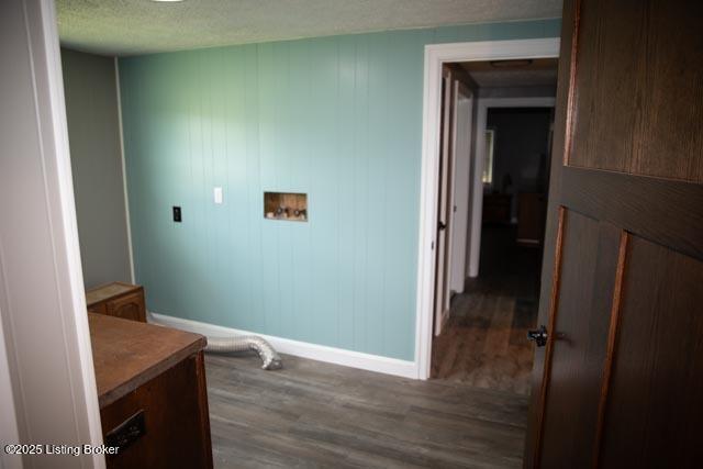 laundry room with washer hookup, dark wood-type flooring, and a textured ceiling