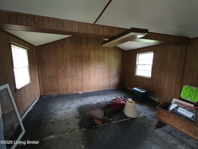 bonus room featuring baseboard heating, vaulted ceiling, and wood walls