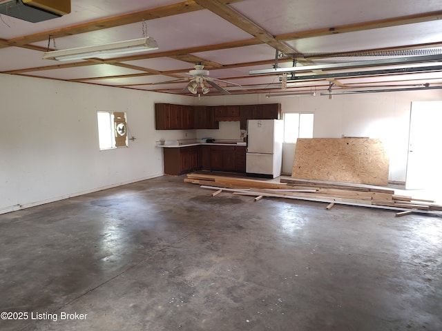 garage with white refrigerator and a garage door opener