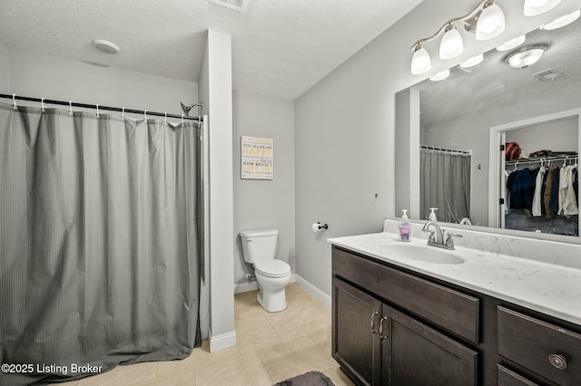 bathroom with toilet, a shower with shower curtain, tile patterned floors, a textured ceiling, and vanity