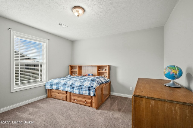 carpeted bedroom featuring a textured ceiling