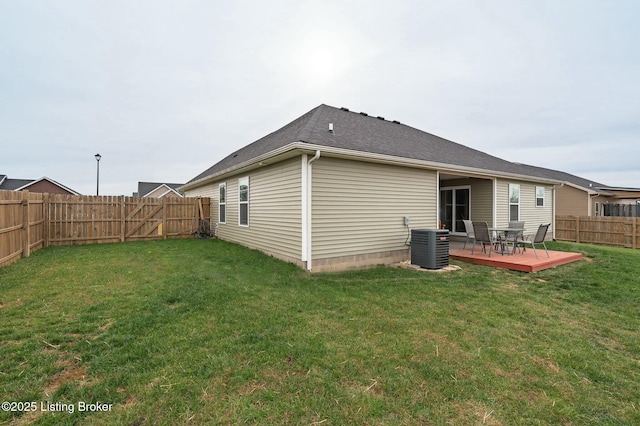 back of property featuring a wooden deck, central air condition unit, and a yard