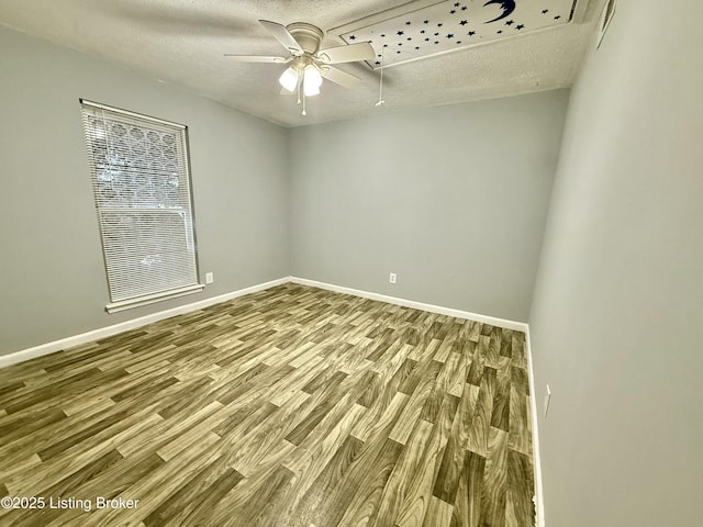 spare room with a textured ceiling, ceiling fan, and hardwood / wood-style flooring