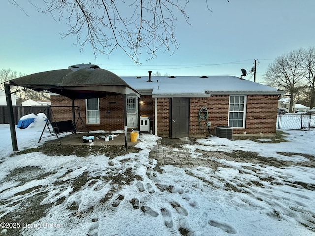 view of snow covered back of property