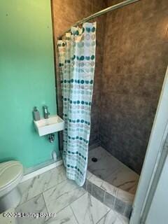 bathroom with curtained shower and toilet