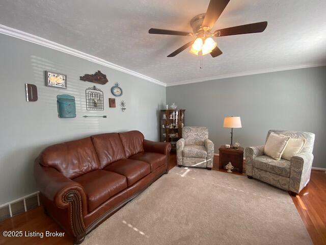 living room with crown molding, a textured ceiling, ceiling fan, and hardwood / wood-style flooring