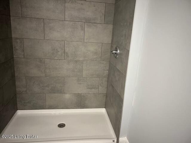 bathroom with tiled shower