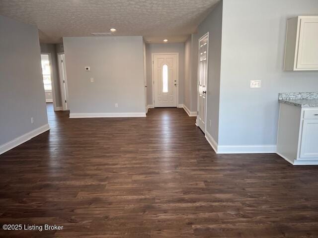 entryway featuring dark hardwood / wood-style flooring and a textured ceiling