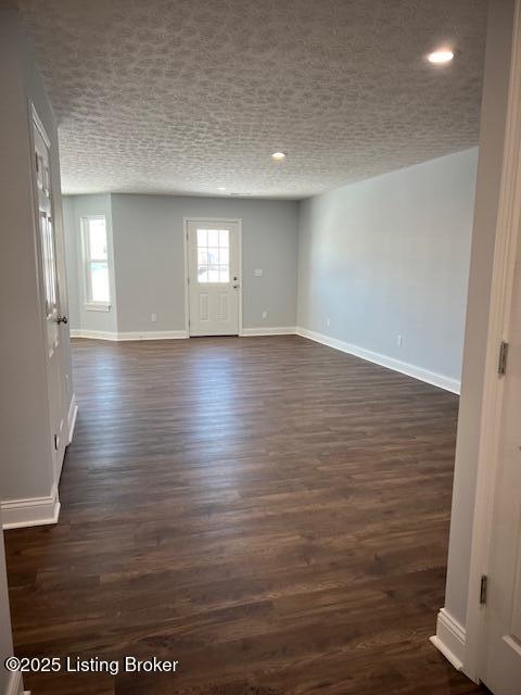 empty room with dark hardwood / wood-style flooring