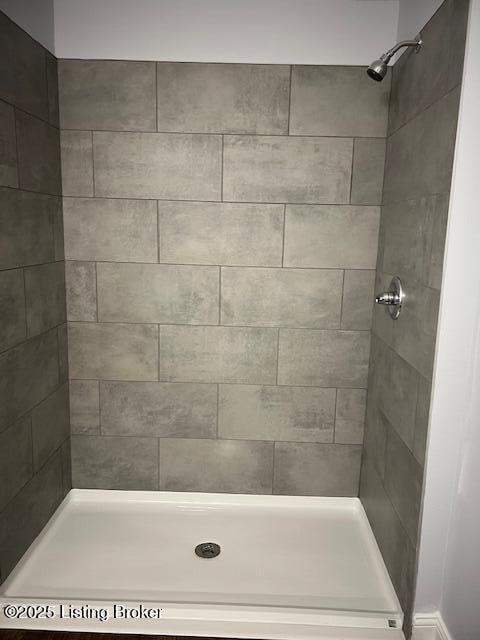 bathroom with tiled shower