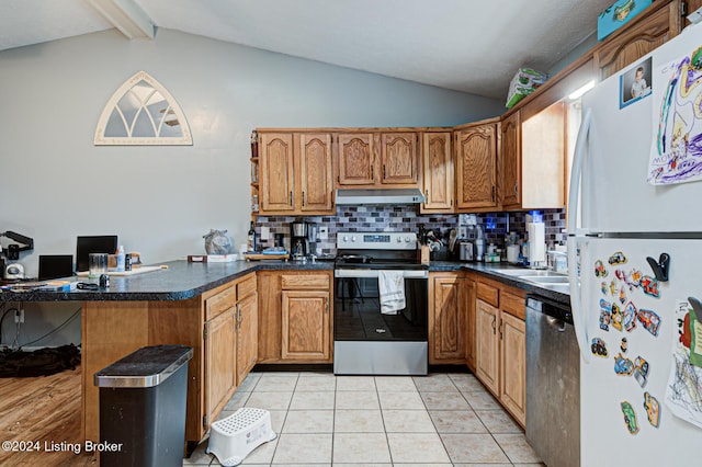 kitchen with appliances with stainless steel finishes, vaulted ceiling with beams, kitchen peninsula, light tile patterned floors, and tasteful backsplash