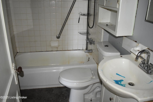 full bathroom featuring toilet, vanity, and tiled shower / bath