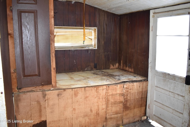 miscellaneous room featuring wood walls