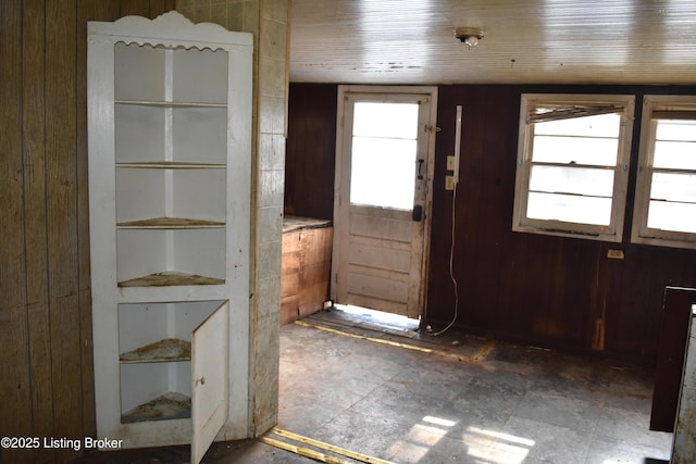 doorway with wooden walls and wooden ceiling