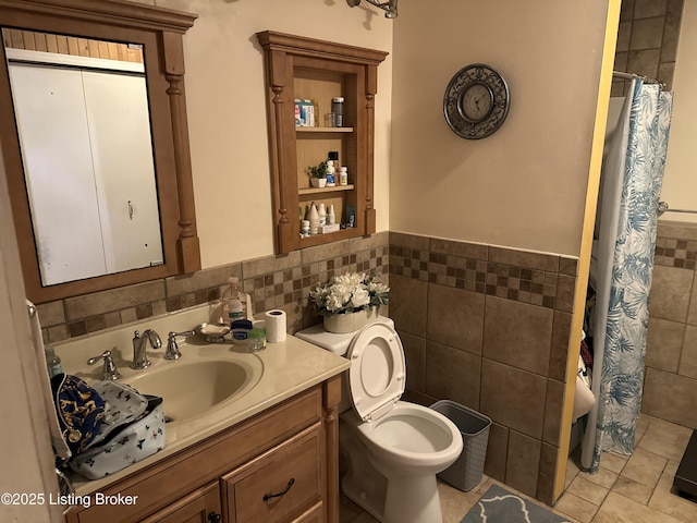 bathroom featuring toilet, walk in shower, tile patterned flooring, tile walls, and vanity