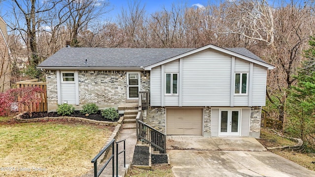 view of front of property with french doors, a front lawn, and a garage