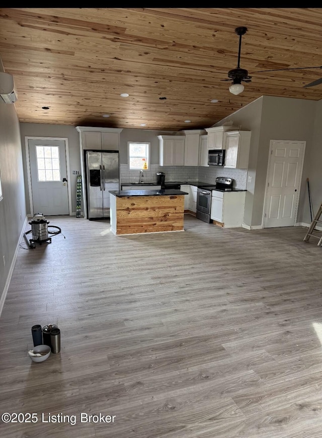 kitchen featuring stainless steel appliances, a wealth of natural light, white cabinets, and wood ceiling