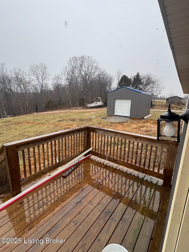 wooden deck with a garage, an outdoor structure, and a lawn