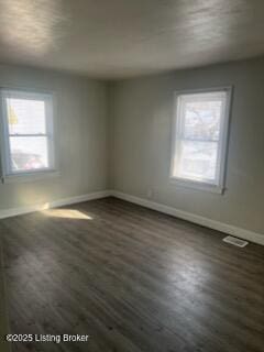 spare room with dark hardwood / wood-style flooring