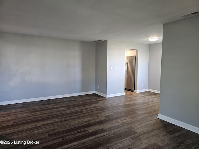 unfurnished room with dark hardwood / wood-style floors