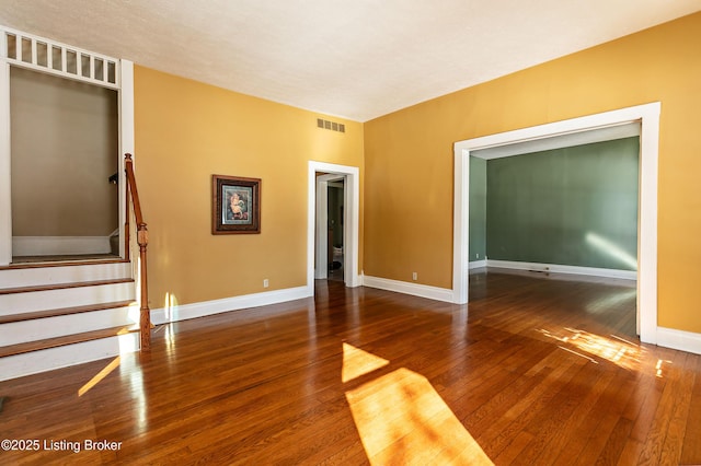 empty room with dark hardwood / wood-style floors