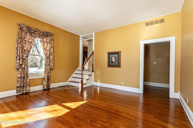 unfurnished room featuring dark hardwood / wood-style floors