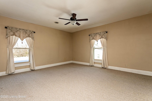 carpeted empty room featuring ceiling fan and plenty of natural light