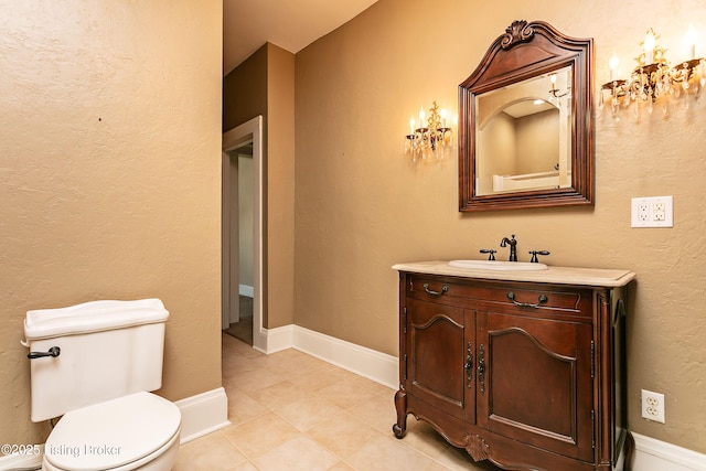 bathroom with toilet, tile patterned flooring, and vanity