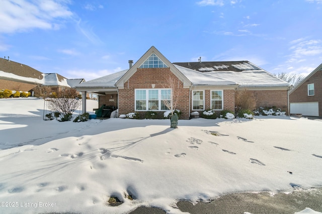 view of snow covered back of property