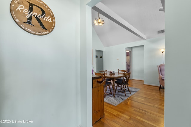 dining space featuring hardwood / wood-style flooring and a notable chandelier