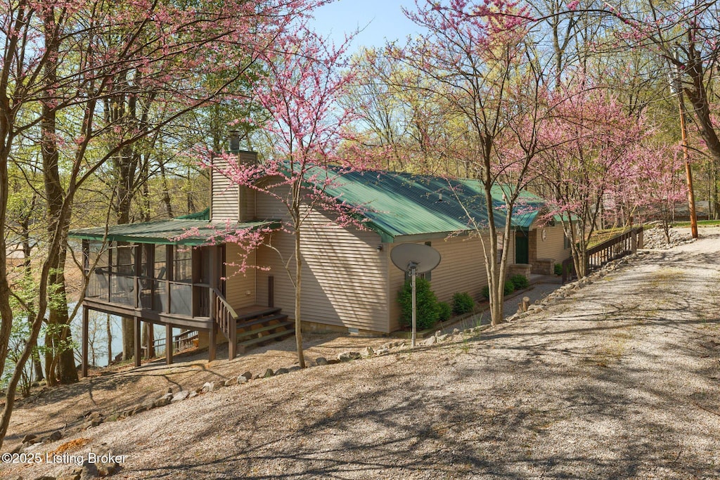 view of home's exterior with a sunroom