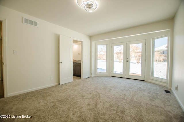 interior space featuring light colored carpet and french doors