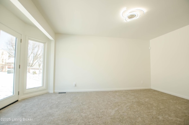 empty room featuring carpet floors and plenty of natural light