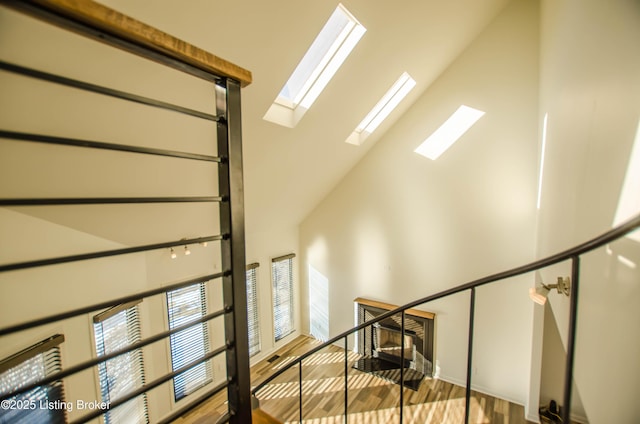 staircase featuring a high ceiling and hardwood / wood-style floors