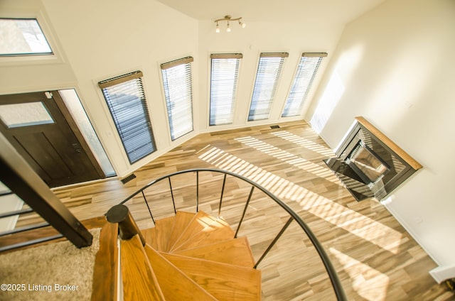 staircase featuring basketball court and hardwood / wood-style flooring