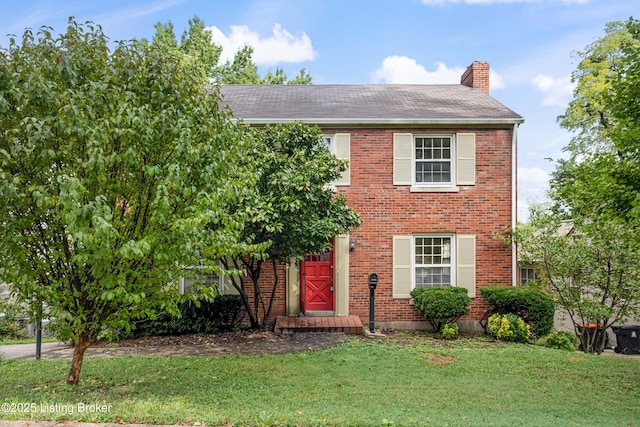 colonial-style house with a front yard