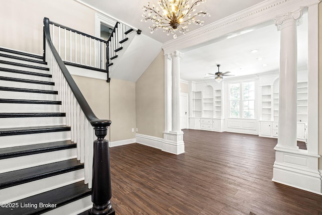 staircase featuring built in shelves, ceiling fan with notable chandelier, ornamental molding, and hardwood / wood-style floors