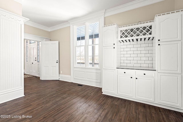 mudroom featuring dark hardwood / wood-style flooring and ornamental molding