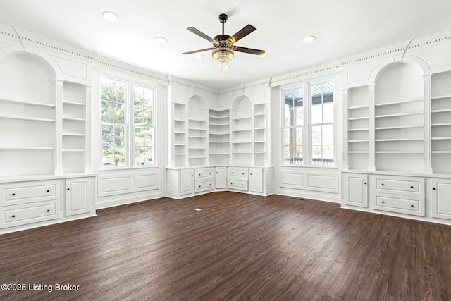 unfurnished living room featuring ceiling fan, built in features, and dark hardwood / wood-style flooring