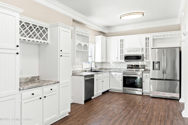 kitchen featuring appliances with stainless steel finishes, dark hardwood / wood-style floors, light stone countertops, white cabinets, and sink