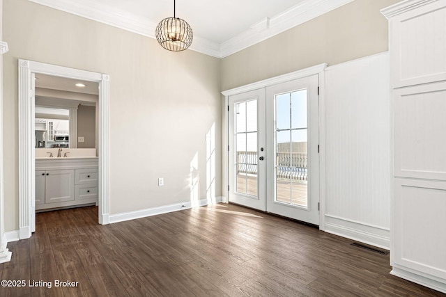 interior space with dark hardwood / wood-style flooring, french doors, sink, a notable chandelier, and crown molding