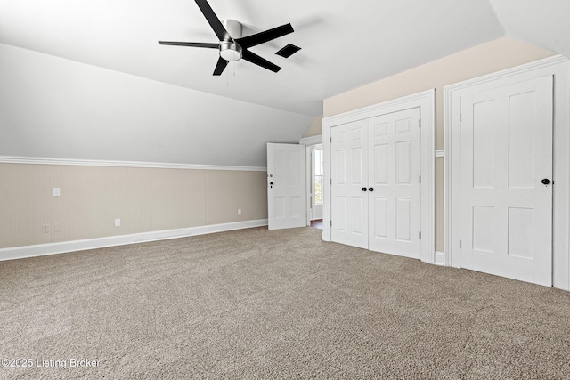 bonus room with ceiling fan, carpet flooring, and vaulted ceiling