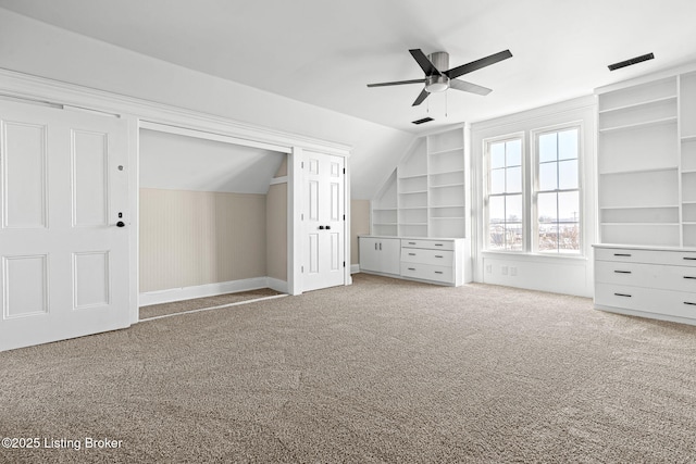 unfurnished bedroom featuring vaulted ceiling, ceiling fan, and carpet floors