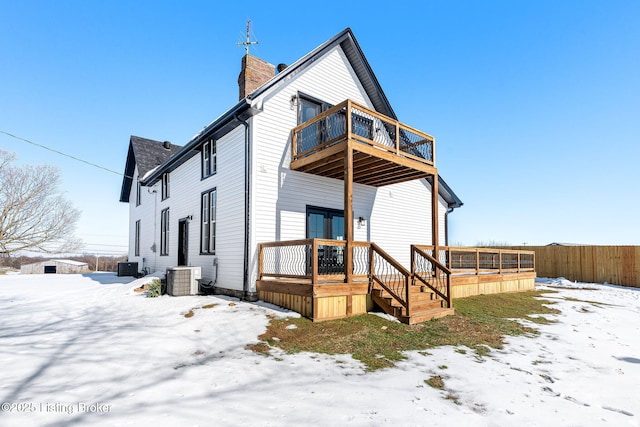 view of front of property featuring central AC unit and a balcony