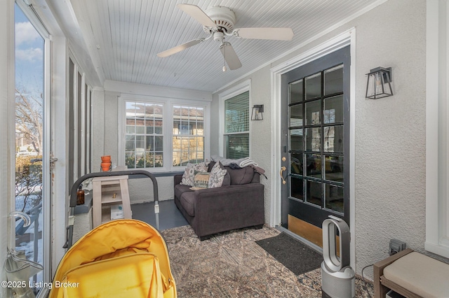 sunroom / solarium featuring ceiling fan