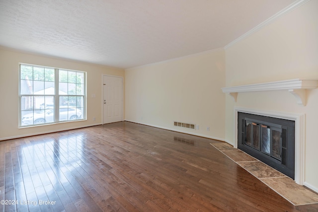 unfurnished living room with hardwood / wood-style floors and ornamental molding