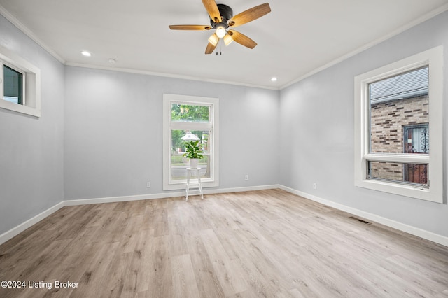 unfurnished room with ceiling fan, light wood-type flooring, and crown molding