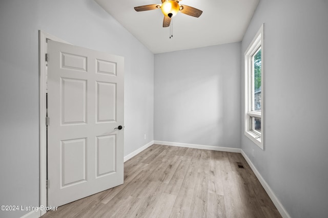 spare room with ceiling fan, light hardwood / wood-style floors, and lofted ceiling