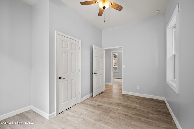 unfurnished bedroom with ceiling fan and light hardwood / wood-style flooring