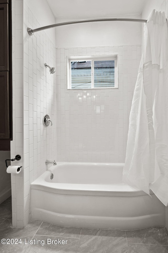 bathroom with tile patterned flooring and shower / bathtub combination with curtain